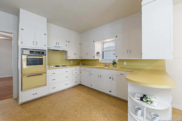 a kitchen with wooden cabinets and sink