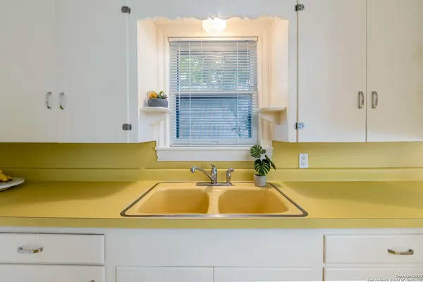 a bathroom with a bathtub and next to a window