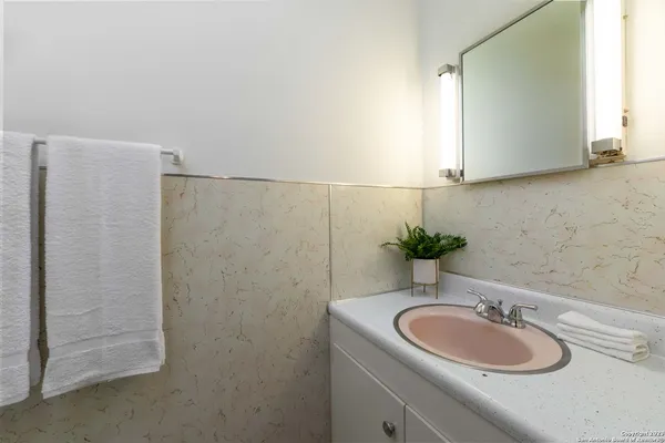 a bathroom with a sink and a mirror