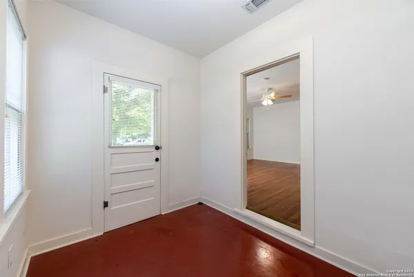 an empty room with windows and closet