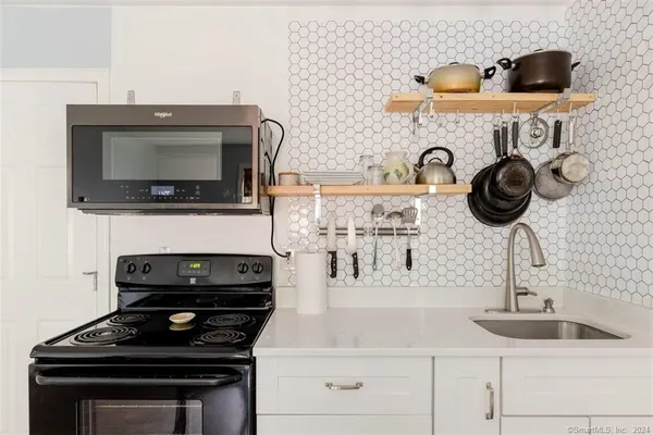 a kitchen with stainless steel appliances dining table and chairs
