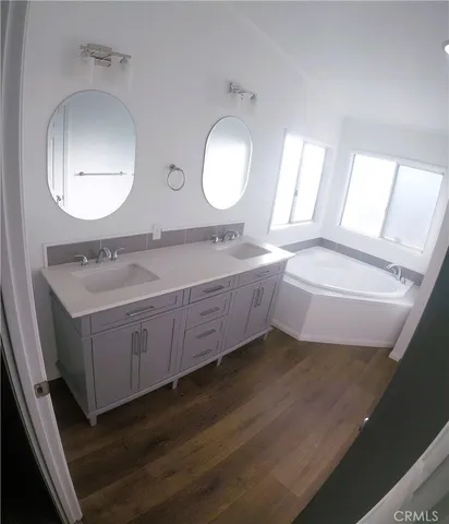 a spacious bathroom with a double vanity sink and a mirror