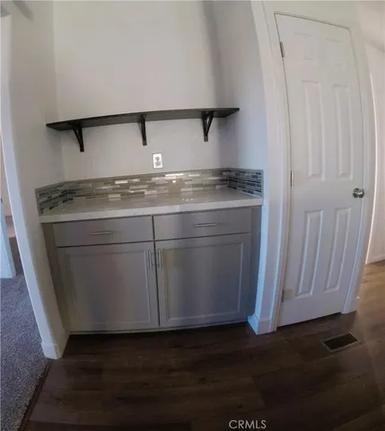 an empty room with wooden floor