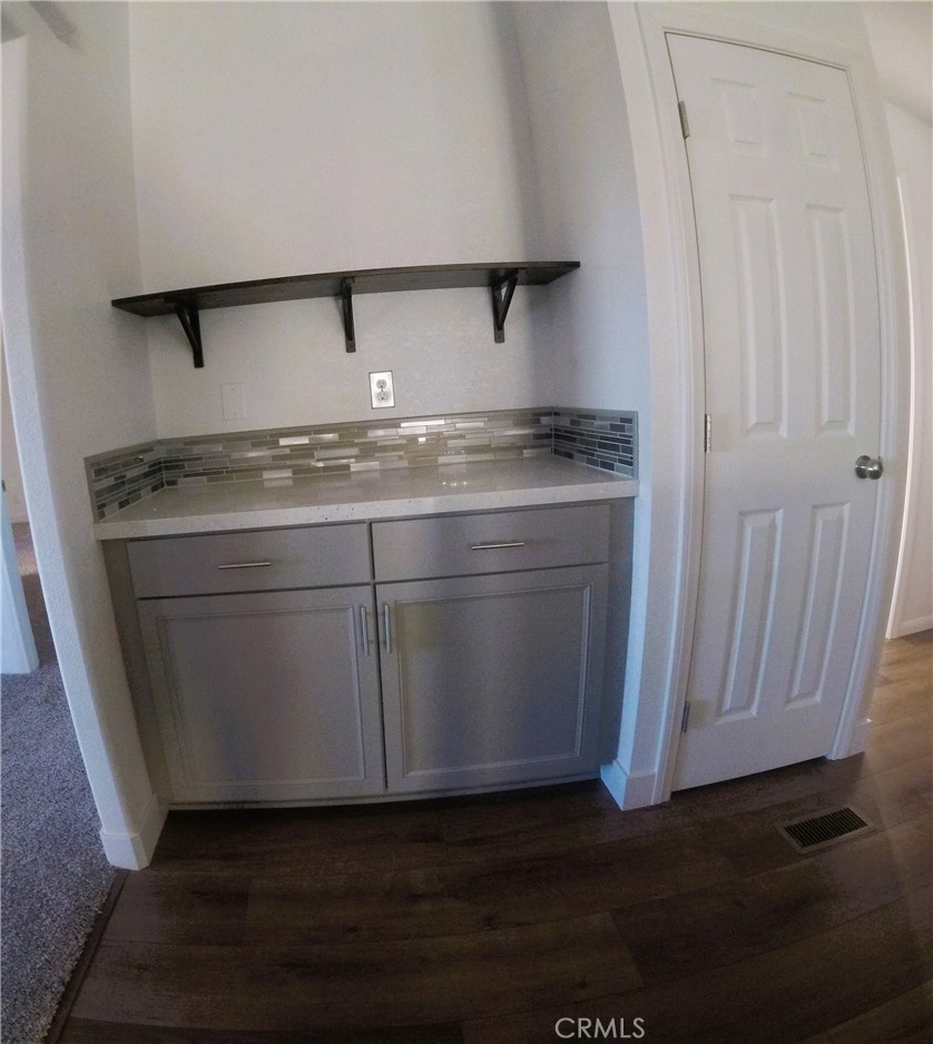 14058 Monte Vista Road Phelan, CA 92371 - Photo 4 of 17 an empty room with wooden floor