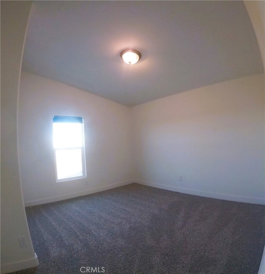 14058 Monte Vista Road Phelan, CA 92371 - Photo 6 of 17 an empty room with a window and an empty room