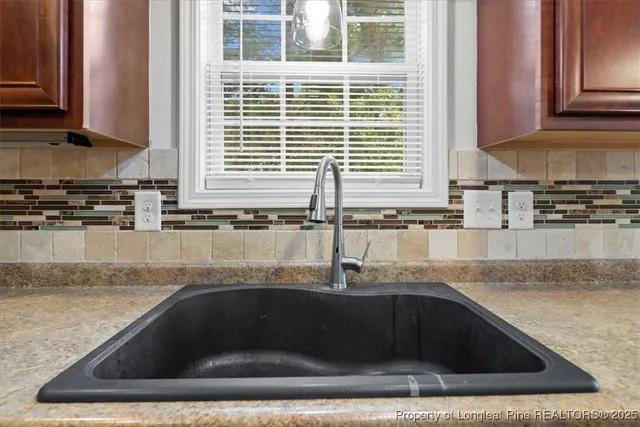 a kitchen with granite countertop a sink and a stove