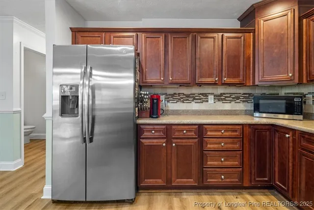 a kitchen with stainless steel appliances granite countertop a refrigerator and a sink