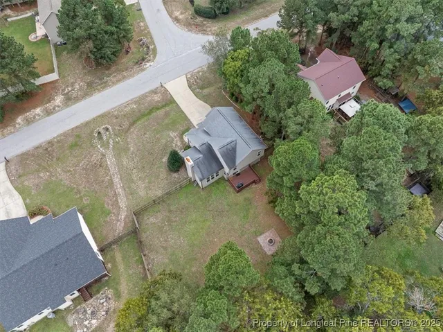 an aerial view of a house with outdoor space and a lake view