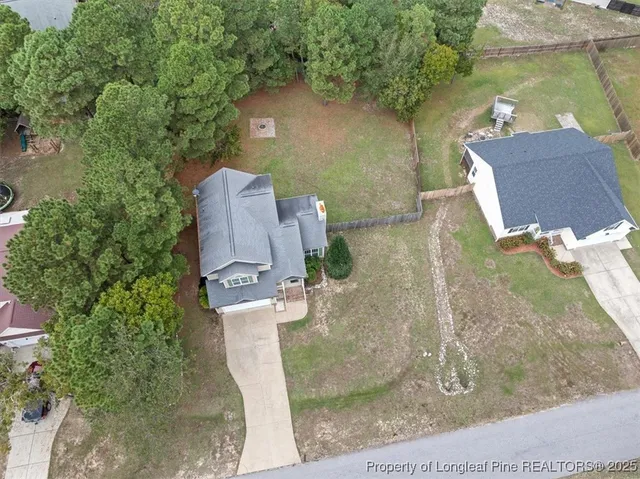 an aerial view of a house with a yard