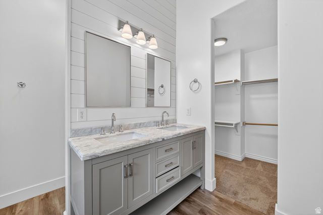 14771 Haddington Road Draper, UT 84020 - Photo 20 of 44 Dual vanity with a stone countertop, individual mirrors, and modern lighting