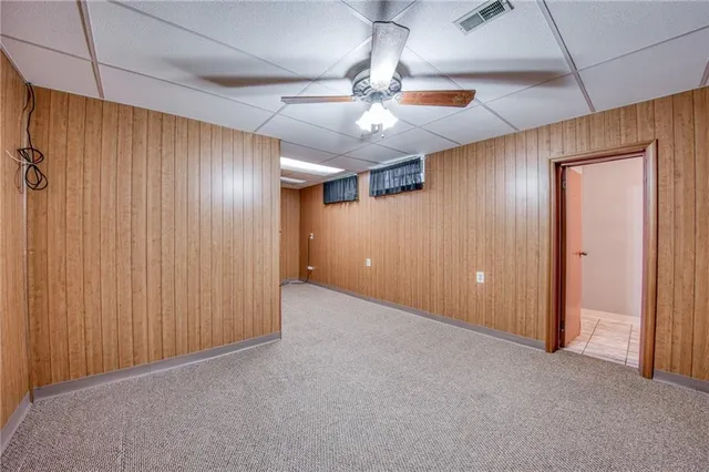 a bathroom with a toilet sink vanity and mirror