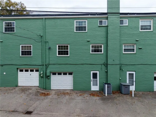 a front view of a house with parking space