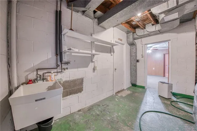 a bathroom with a granite countertop shower and a sink