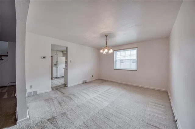 an empty room with a windows and ceiling fan