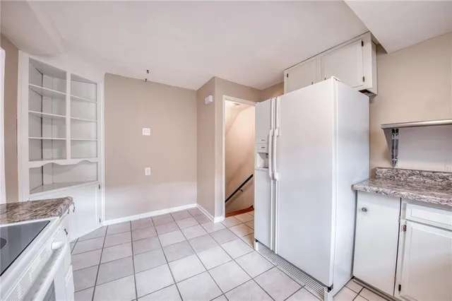 a view of a kitchen with a refrigerator and cabinets