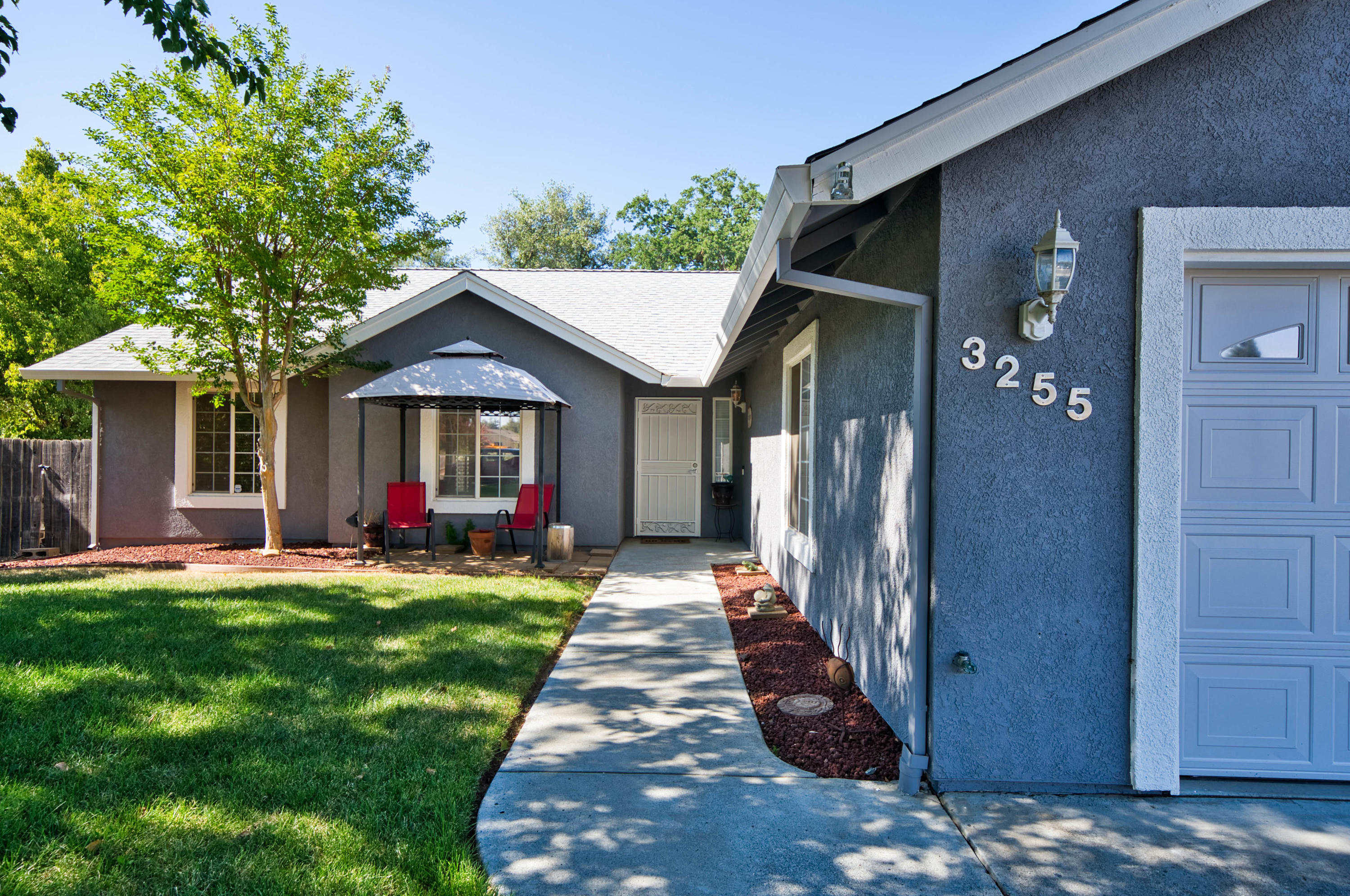 3255 Lawrence Road Redding, CA 96002 - Photo 2 of 27 a front view of a house with yard and green space