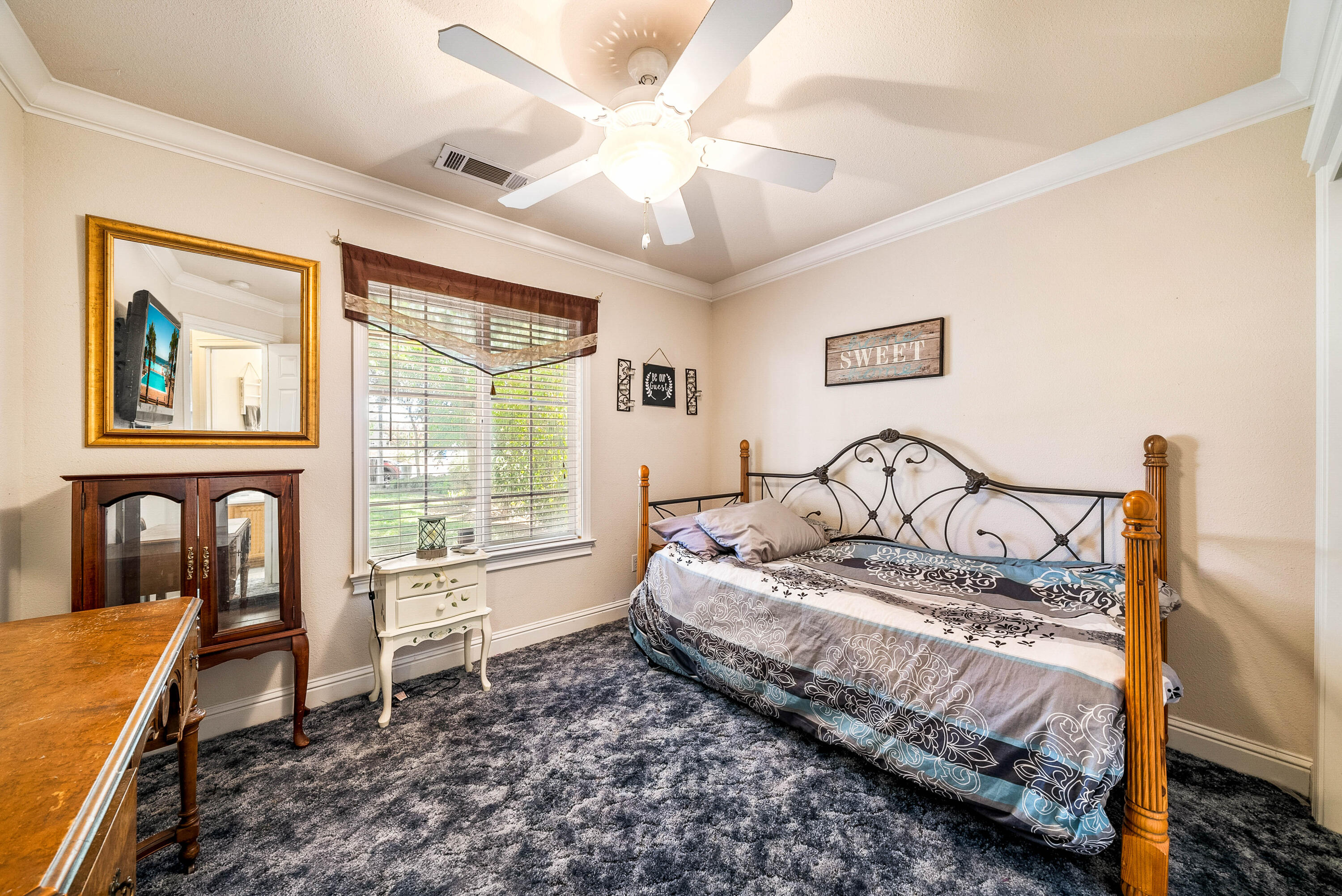 3255 Lawrence Road Redding, CA 96002 - Photo 21 of 27 a bedroom with a bed next to a window with a workspace