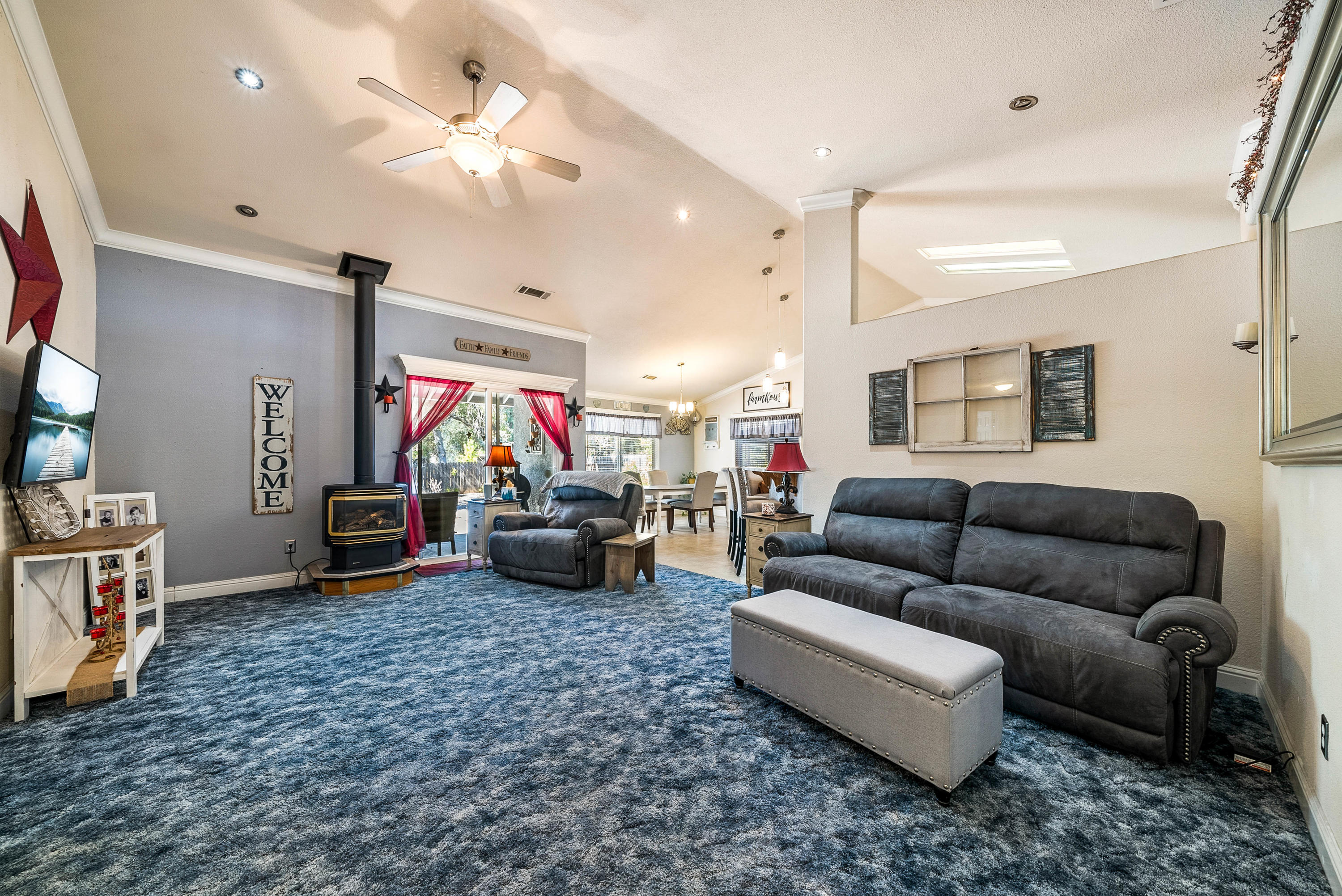 3255 Lawrence Road Redding, CA 96002 - Photo 9 of 27 a living room with furniture a ceiling fan and a rug