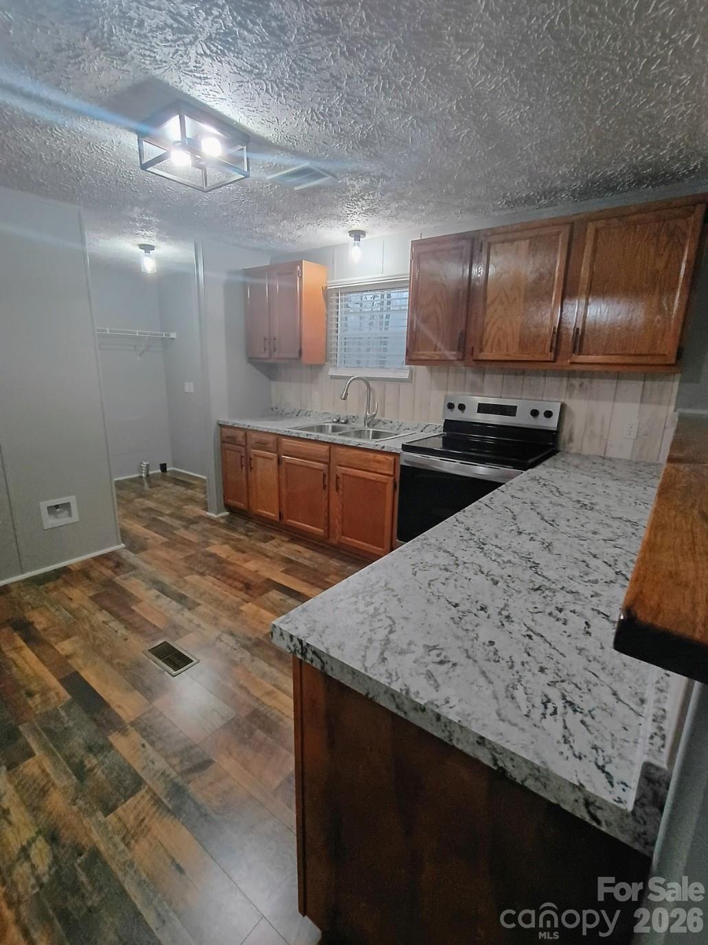 308 Chimney Rock Road Rutherfordton, NC 28139 - Photo 11 of 23 a kitchen with stainless steel appliances granite countertop a sink stove and cabinets