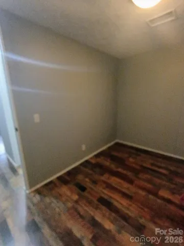 a view of a room with wooden floor and window