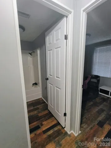 a view of kitchen cabinets and wooden floor