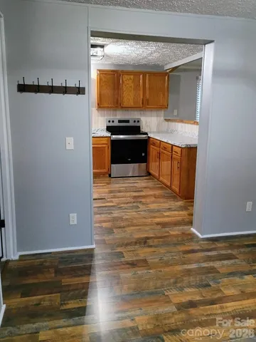 a kitchen with granite countertop a sink and cabinets