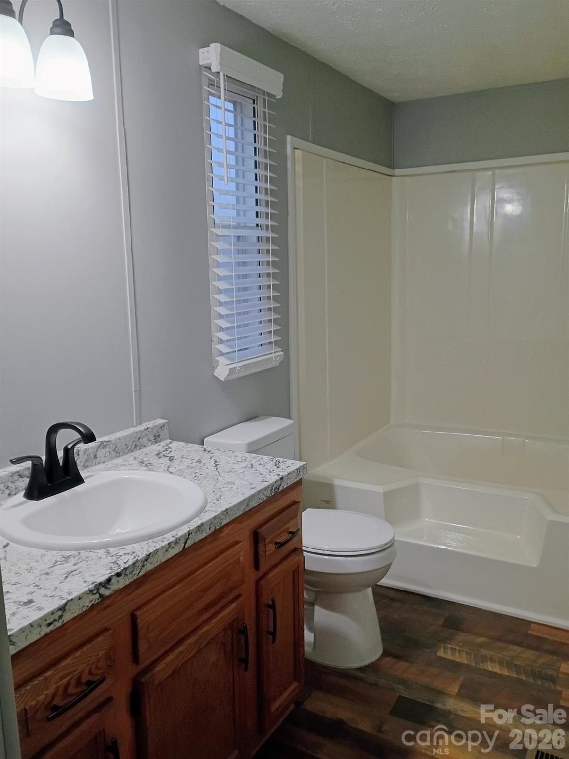 308 Chimney Rock Road Rutherfordton, NC 28139 - Photo 5 of 23 a bathroom with a granite countertop sink a toilet and shower