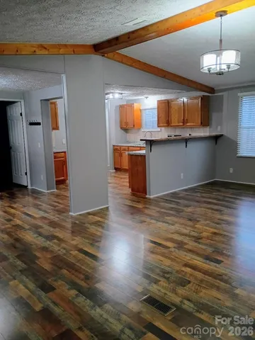 a view of a room with wooden floor