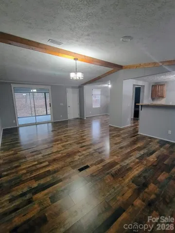 a kitchen with stainless steel appliances granite countertop a sink a stove counter space and cabinets