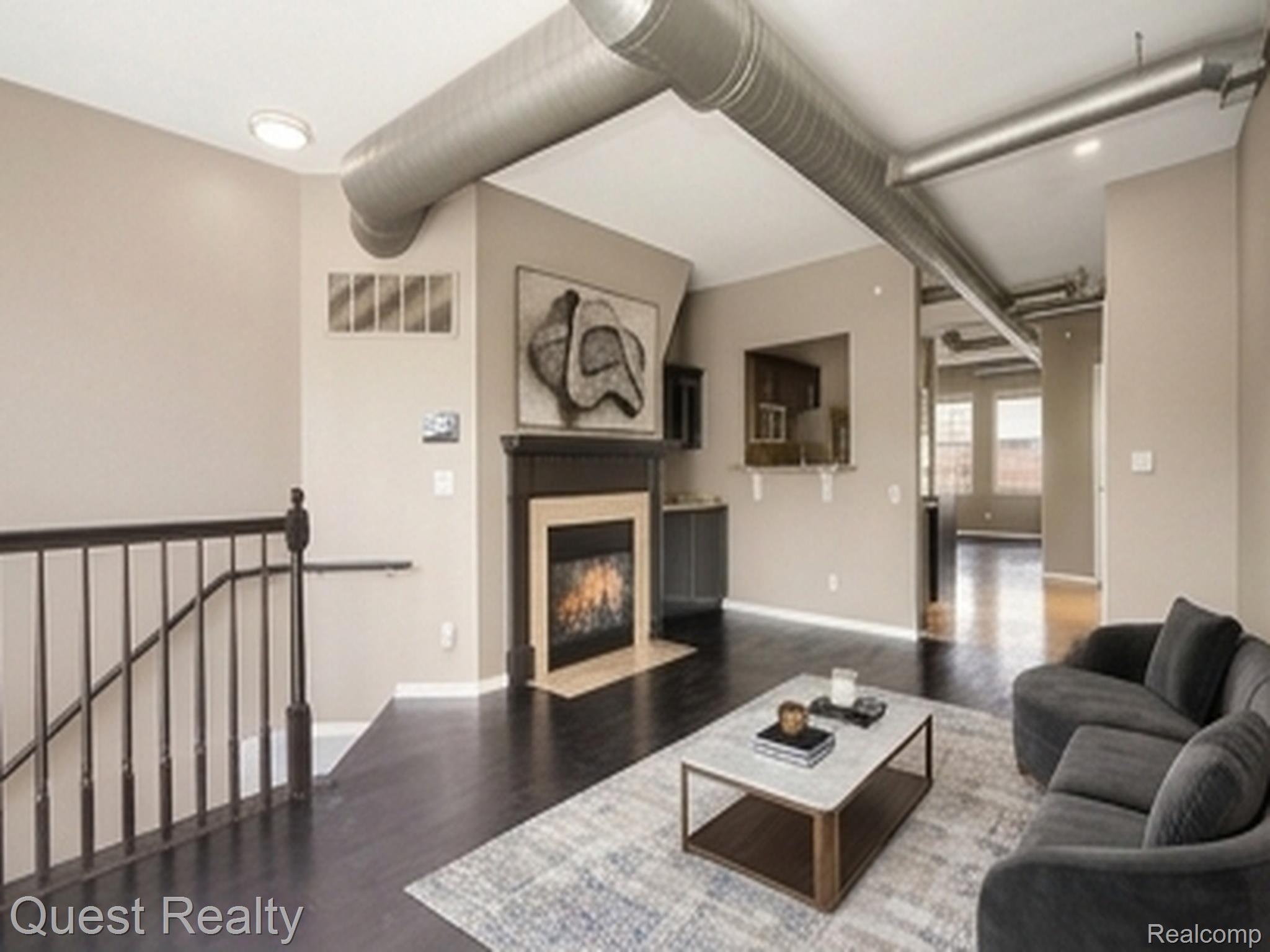 218 Mill Street Rochester, MI 48307 - Photo 4 of 28 Hardwood flooring, fireplace with stone hearth, exposed ductwork, recessed lighting, and patio access