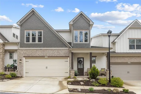 a front view of a house with a yard and garage