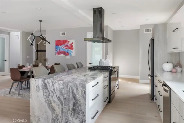 a kitchen with cabinets appliances and a window