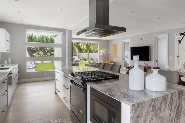 a kitchen with a stove a sink and a refrigerator