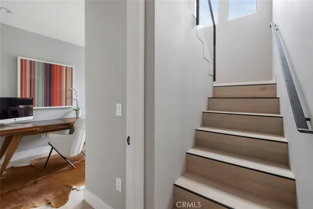 a bedroom with a bed lamp and a large window