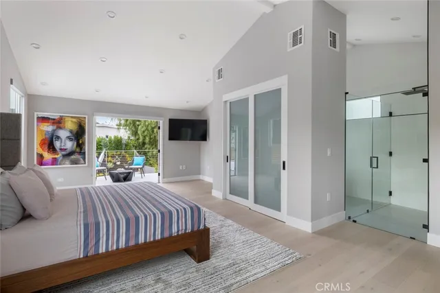 a bedroom with bed and glass door