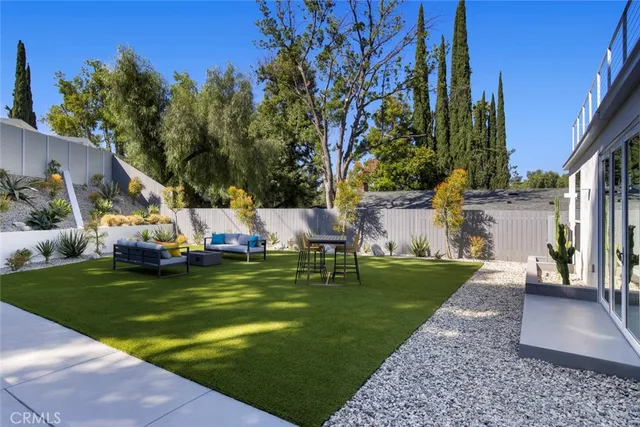 a swimming pool with outdoor seating and yard