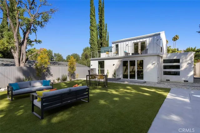 a swimming pool with outdoor seating and yard