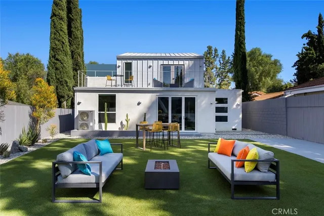 a view of a patio with table and chairs with wooden fence