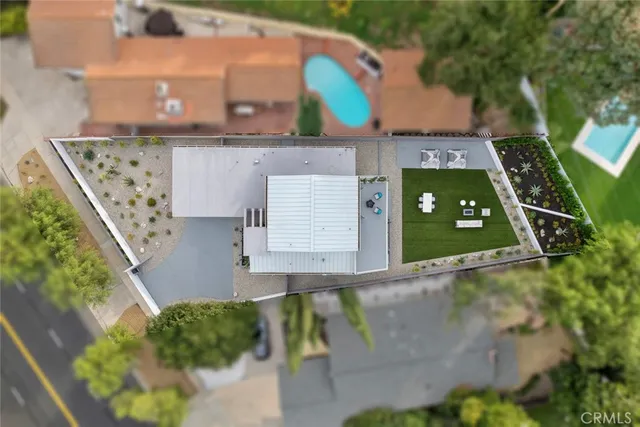 a living room with furniture kitchen view and a wooden floor