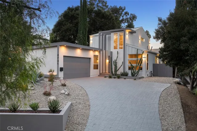 a kitchen with stainless steel appliances granite countertop a sink refrigerator and cabinets