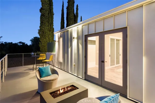 a view of an house with backyard and sitting area