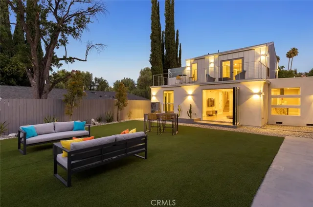 a view of a patio with table and chairs and potted plants