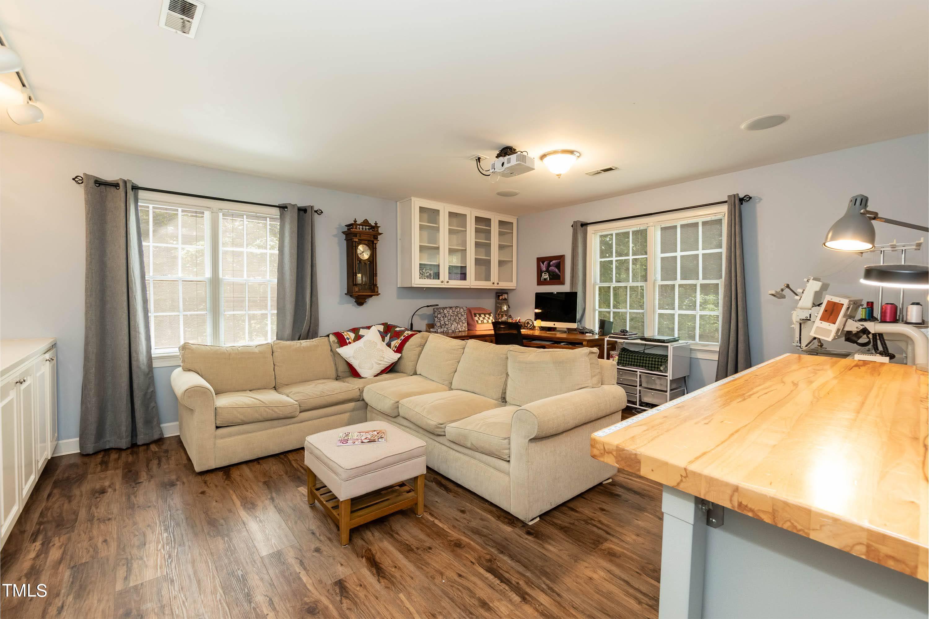 4112 Ridgebrook Bluffs Drive Raleigh, NC 27603 - Photo 37 of 40 So many options for this large bonus room with a wall of shelving and cabinets