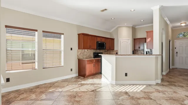 a view of kitchen with sink and refrigerator