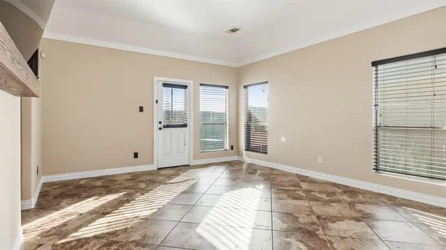 a view of an empty room with glass door