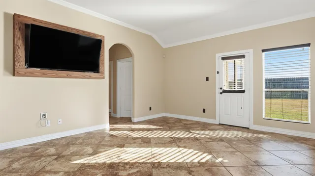 a view of a livingroom with wooden floor and flat screen tv