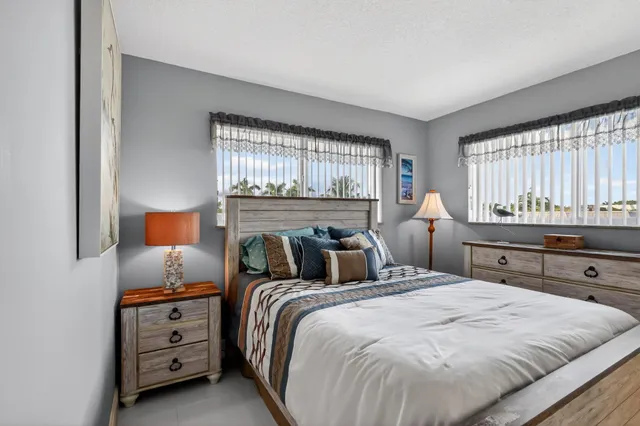 a living room with furniture a table and a potted plant