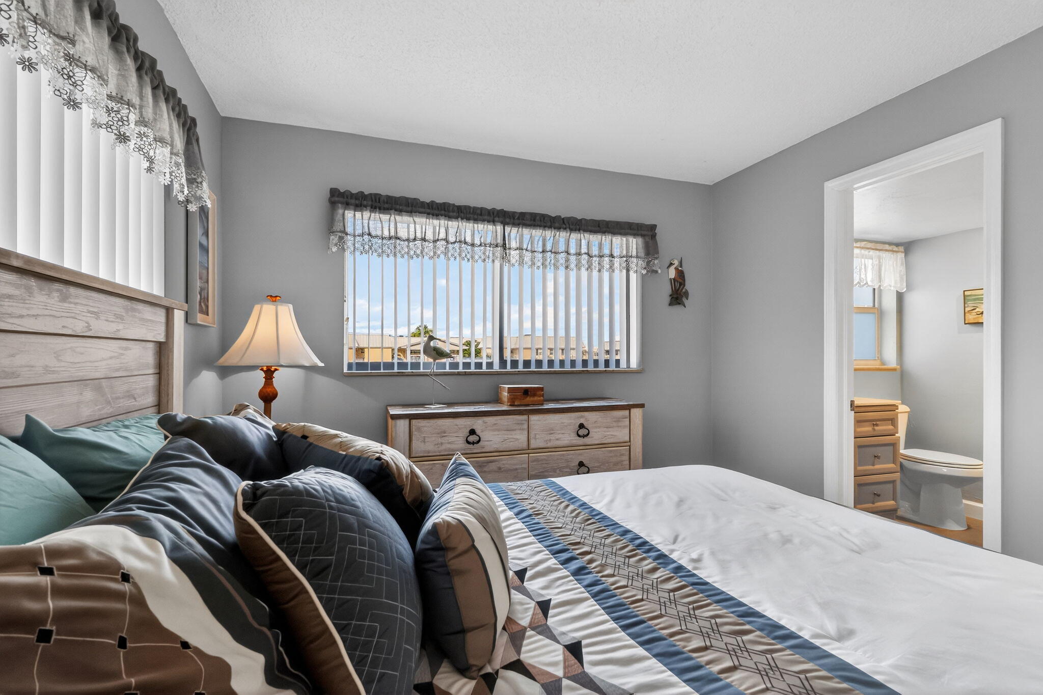 12 Colonial Club Drive, Unit 305 Boynton Beach, FL 33435 - Photo 14 of 51 a bedroom with a bed and wooden floor