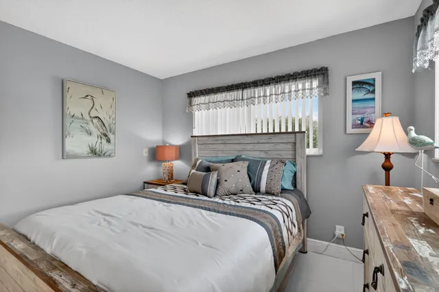 a bathroom with a granite countertop toilet a sink and a mirror