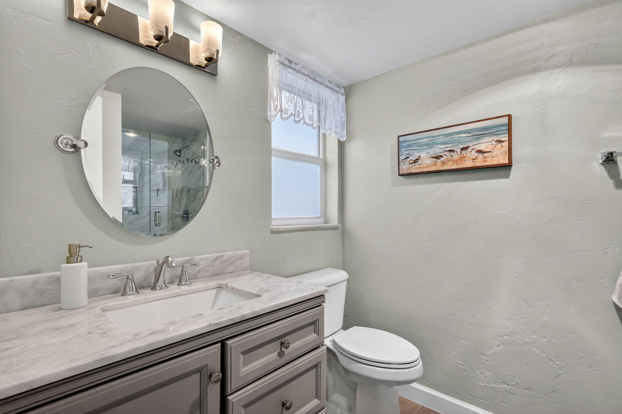 12 Colonial Club Drive, Unit 305 Boynton Beach, FL 33435 - Photo 16 of 51 a bathroom with a granite countertop toilet a sink and a mirror